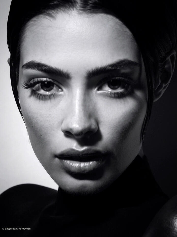 Baseerat Al-Rumayyan in a deep red pleated halter-neck gown, standing against a clean white wall with minimal shadows, exuding bold elegance and timeless beauty.